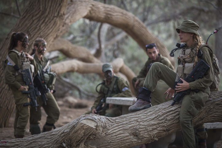 Soldiers of the Caracal Battalion seen resting before beginning a 16 Kilometer journey overnight to complete their training course, in Azoz village, southern Israel, near the border with Egypt, September 3, 2014. Formed in 2004, the Caracal Battalion is an infantry combat battalion of the Israel Defense Forces, composed of both male and female soldiers, which is stationed along the Egyptian border. Most of the Caracal soldiers are female. Photo by Hadas Parush/Flash90 *** Local Caption *** ???? ???? ???? ??? ????? ????? ???? ????? ?????? ?????? ???? ????? ??? ????? ??"? ????? ??????